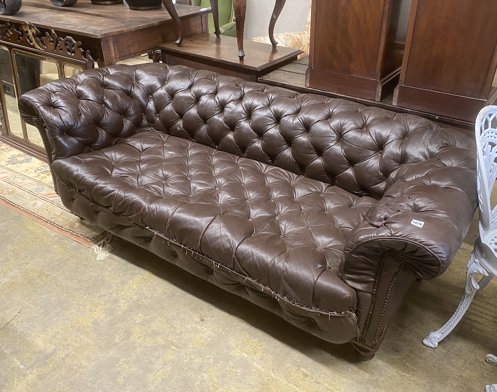 A Victorian buttoned brown leather Chesterfield settee, length 200cm, depth 84cm, height 66cm